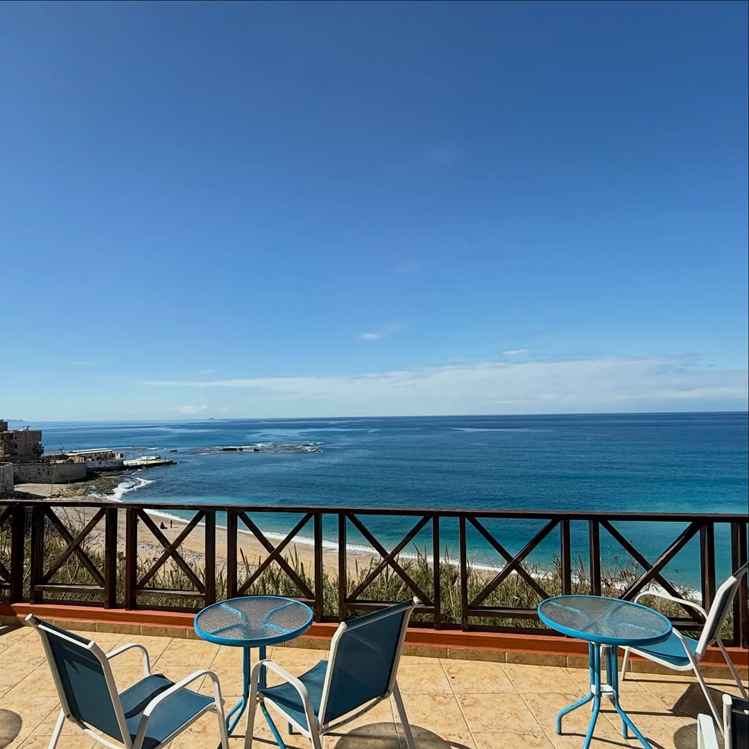 The hotel terrace with tables overlooking the bay and beach of Byblos
